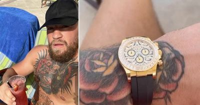 Conor McGregor shrugs off criticism by flaunting wealth and drinking cocktails