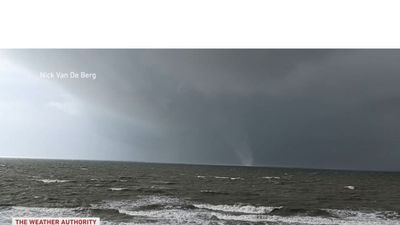 Beachgoers run for cover as waterspout turns into tornado in Florida