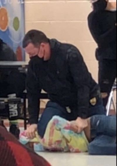 Off-duty police officer accused of kneeling on 12-year-old girl’s neck at Wisconsin school in viral video