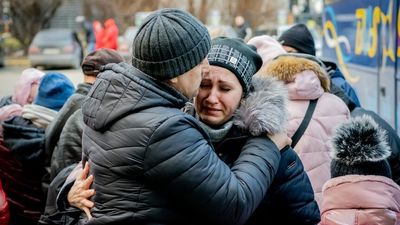 Ukraine's women and children are fleeing the country, leaving their men with a lonely choice on how to fight Russia's war