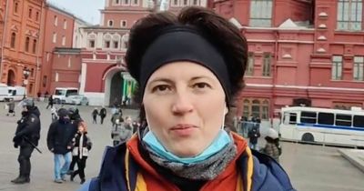 Moment Russian woman is marched away by police in 3 seconds for holding 2-word placard