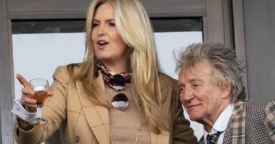 Rod Stewart plants cheeky kiss on wife Penny as they lead celebs at Cheltenham races