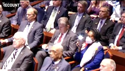 Joe Manchin seen swiping on iPad while Marjorie Taylor Greene looks for phone during Zelensky’s speech