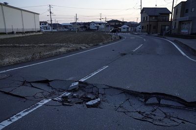 Quake in Japan kills two, halts factories, cuts power to thousands of homes