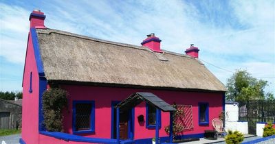 Traditional 18th century Irish thatched-roof cottage for sale in Galway for €375,000 - but it's bright pink