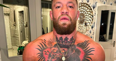 UFC star Conor McGregor gives a glimpse inside his mother's glam home as he works out in kitchen