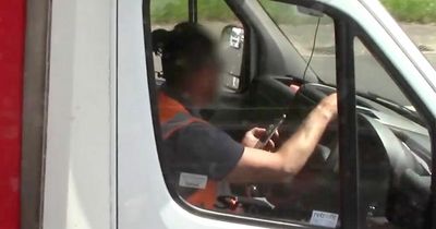 Brazen lorry driver seen using phone without seatbelt on and giving cops middle finger