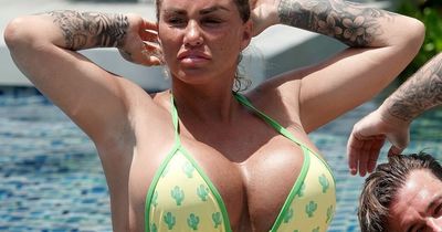 Katie Price grimaces in the blazing Thai sunshine as she almost falls into pool