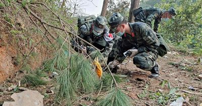 China plane crash: Witness says he heard 'bangs like thunder' as burnt ID cards found