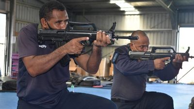 Solomon Islands police show off fake guns given to them by Chinese government after 'secret' delivery