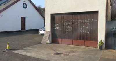 Fuming Edinburgh pensioner leaves massive warning to dog walkers on his garage