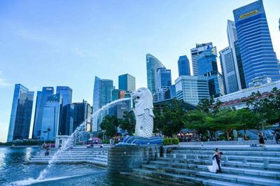 Singapore eases virus curbs, including vaccinated travel