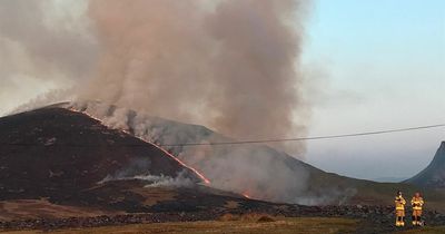Huge wildfire spreads across mountains as people are urged to close windows and doors