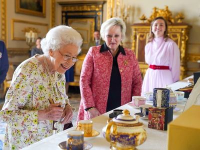 Queen looks delighted as she views hand-crafted artefacts at Windsor Castle