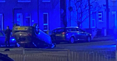 Car flips onto roof after crash with parked car in Fife street