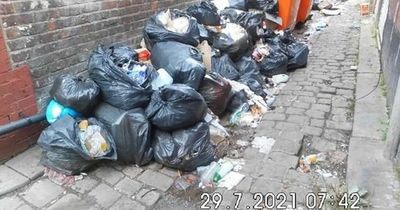 Two south Manchester takeaways slapped with £20,000 fine for dumping piles of rubbish in alleyway