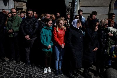 Ukrainian mourners ignore missile risks to attend military funerals