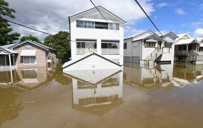 ‘Don’t seem to listen’: authorities urge Queenslanders to avoid flood waters after death toll rises