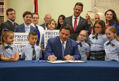 Ron DeSantis signs ‘Don’t Say Gay’ bill into law during staged ceremony surrounded by children