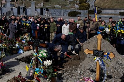 A month into Ukraine’s war with Russia, gravediggers of Lviv mourn the dead