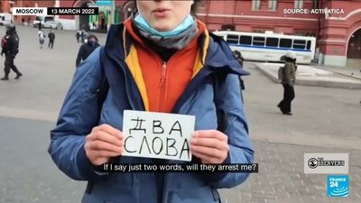 Anti-war protester arrested in Russia for holding up a poster saying 'two words'