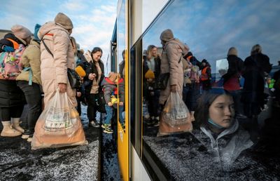 In tears at border, Ukrainians say they held on until they had to flee