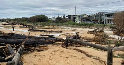 Massive surf sends waves breaking over battered Stockton Beach and into the suburb