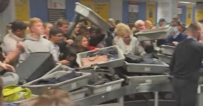 MAYHEM at Manchester Airport as boxes piled high at security and worried holidaymakers 'jump over barriers' as passengers fear 'someone will get hurt'