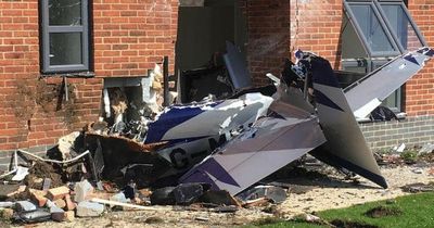 Plane destroyed and pilot in hospital after flying into block of flats