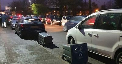 Residents lay out wheelie bins in desperate bid to reserve car parking space