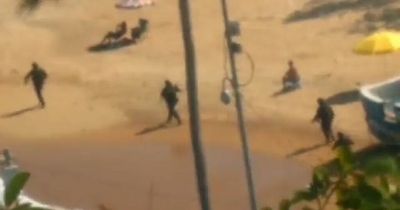 Terrified tourists caught up in gunfight between armed police and hitmen