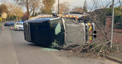 Land Rover flips over after driver swerves to avoid a CAT - but hits a tree instead