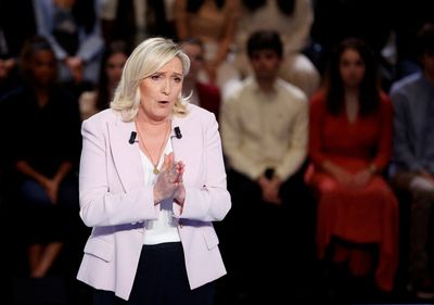Factbox-Far-right Le Pen cloaks nationalist policies with social veneer