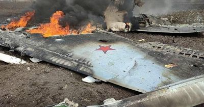 Fiery wreck of Russia’s newest fighter jet burns with pilot kneeling beside it