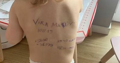Ukrainian mum pens contact details onto toddler's back in case family is killed