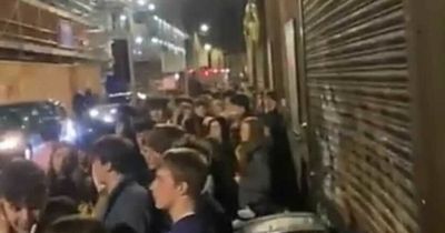 Edinburgh partygoers brave the rain to stand in huge city centre queue