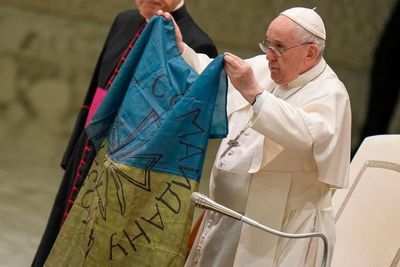 Pope Francis kisses Ukrainian flag from 'martyred' Bucha