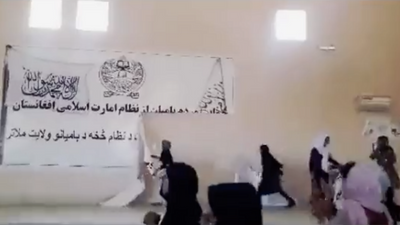 Afghan women rip down banners when Taliban refuse to talk about education