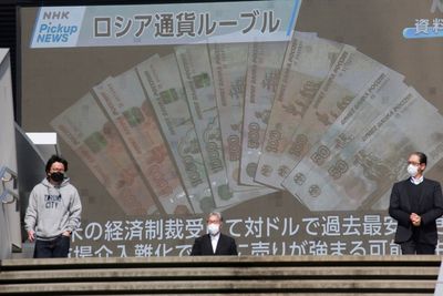 Russia cuts interest rate as ruble settles despite sanctions
