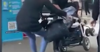 Moment Asda security guard 'pulls woman with pram filled with bottles' back into store