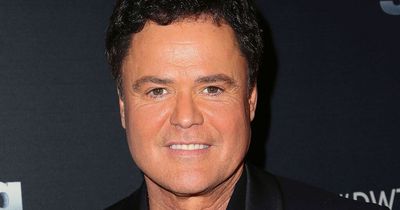 Donny Osmond hugs brother Merrill on stage for emotional final performance