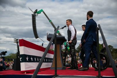 Madison Cawthorn pulls himself out of his wheelchair during Trump rally in North Carolina