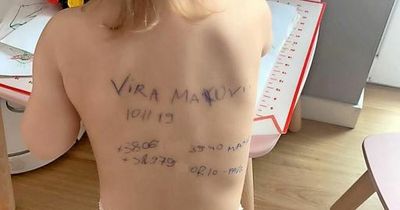 Ukrainian parents writing phone numbers on children as Russian troops loot and torture across country