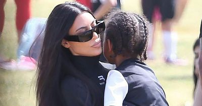 Kim Kardashian rocks £530 top as she cuddles son Saint after watching his football game