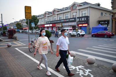 Shanghai eases COVID curbs for some even as factory halts widen