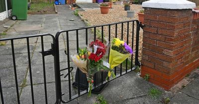 Flowers left at stabbing scene as two still questioned over dad's killing