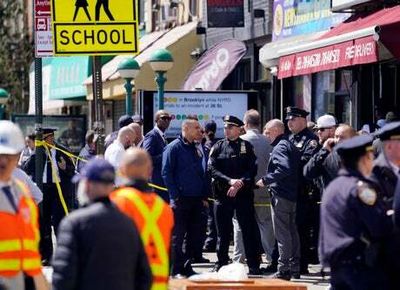 Brooklyn subway shooting: Police hunt gunman who put on gas mask and shot ten people