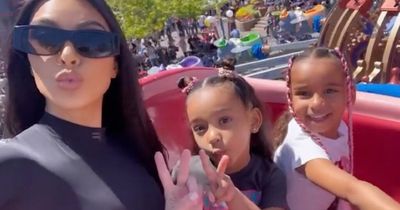 Kim Kardashian's daughter Chicago is her twin as she throws up peace sign for camera