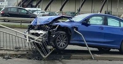 BMW driver smashes into barrier near Trafford Centre