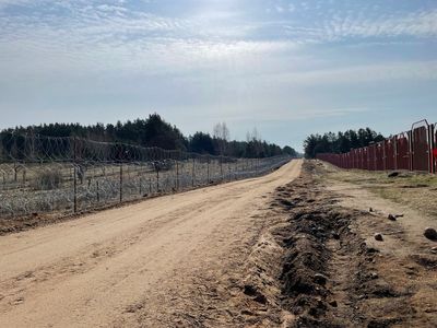 Poland builds a border wall to deter migrants as it welcomes Ukrainian refugees